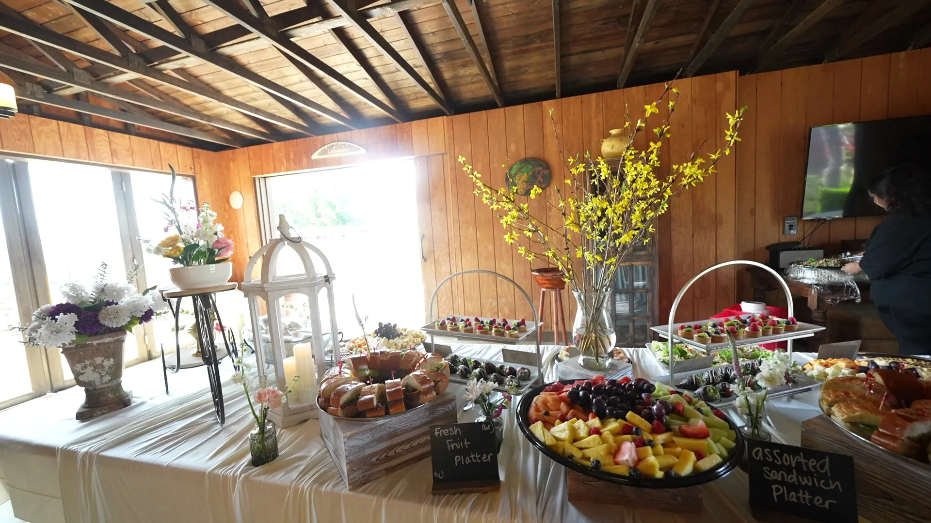 Outdoor buffet table with chafing dishes and platters for a large party