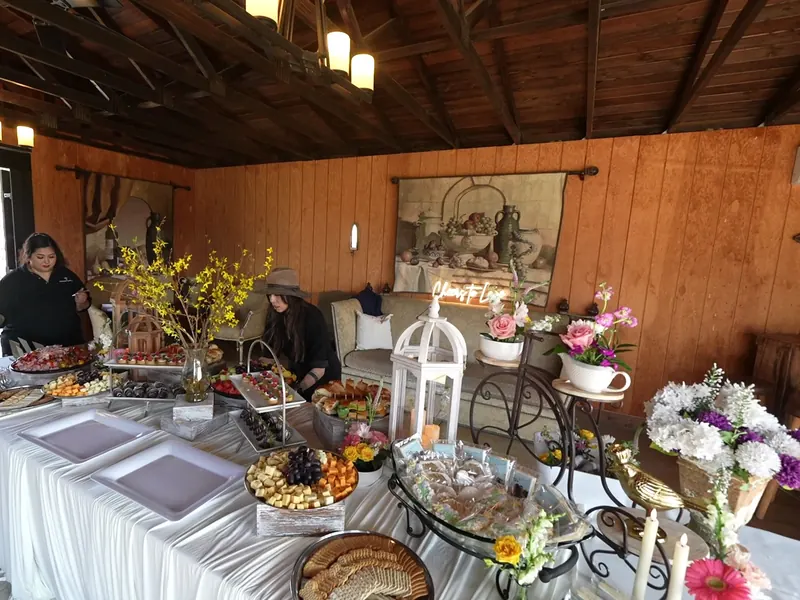 Grazing display of dried fruit, nuts, and fresh fruit on a styled table