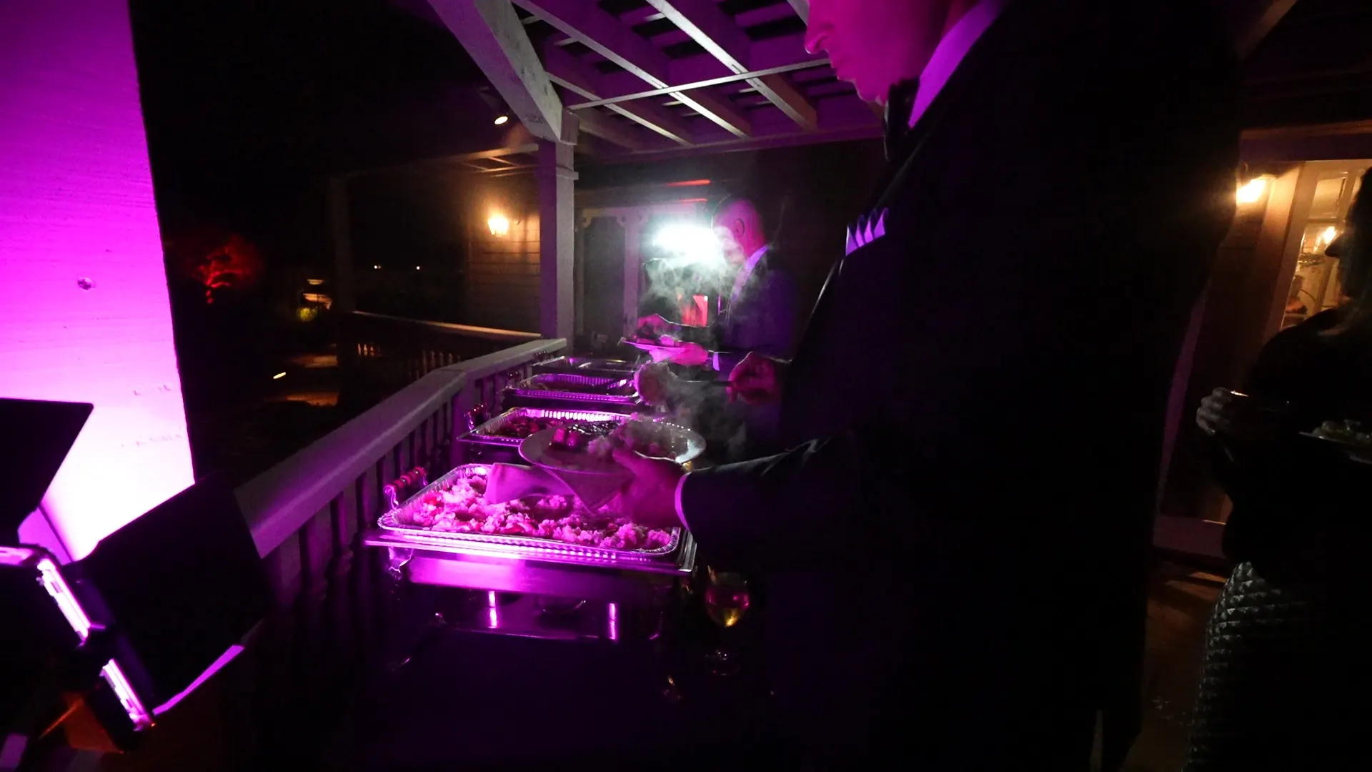 Chafing dishes of pasta, vegetables, and salad set out for a group lunch