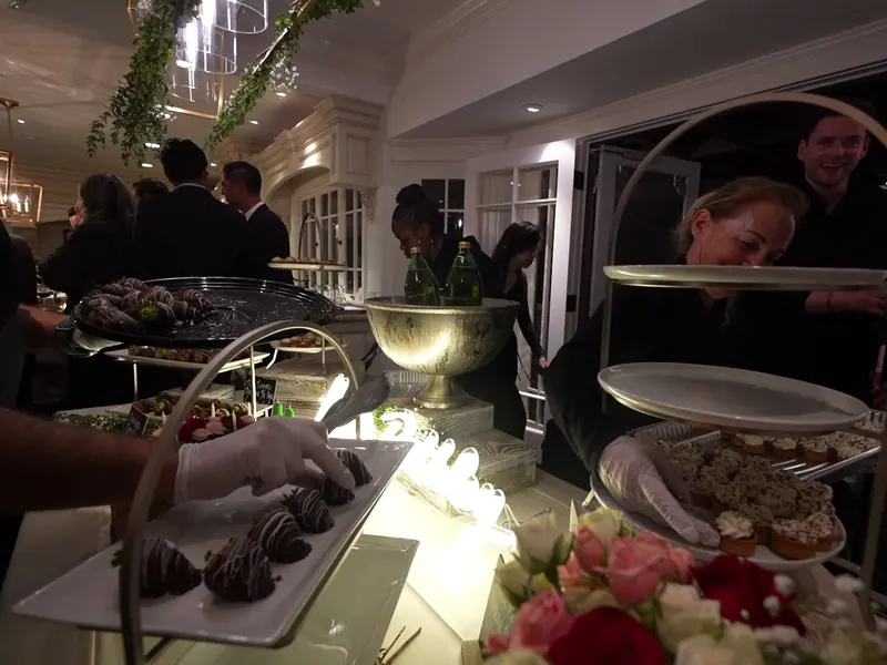 Appetizer station arranged with skewers, bruschetta, and crudité