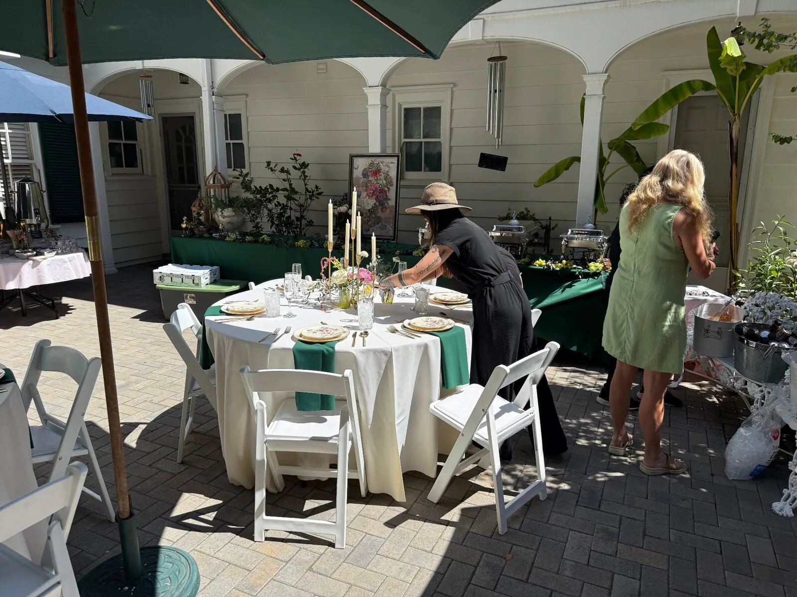 Courtyard reception setup with linened tables, place settings and buffet stations at a Clayton venue by Winslow's Catering Concord