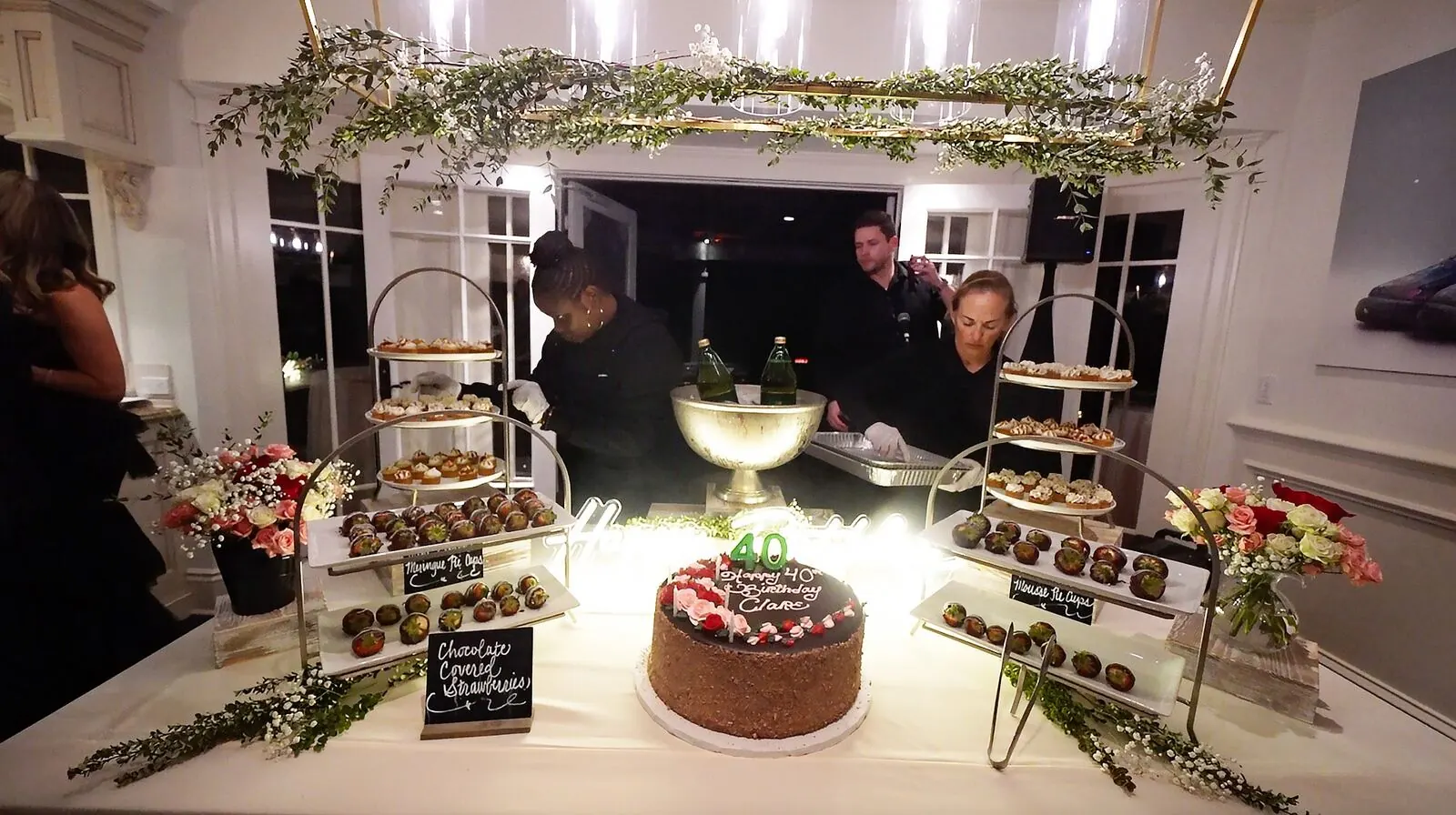 Dessert display of mini pastries, tarts and chocolate-dipped strawberries at a Martinez celebration catered by Winslow's Catering Concord