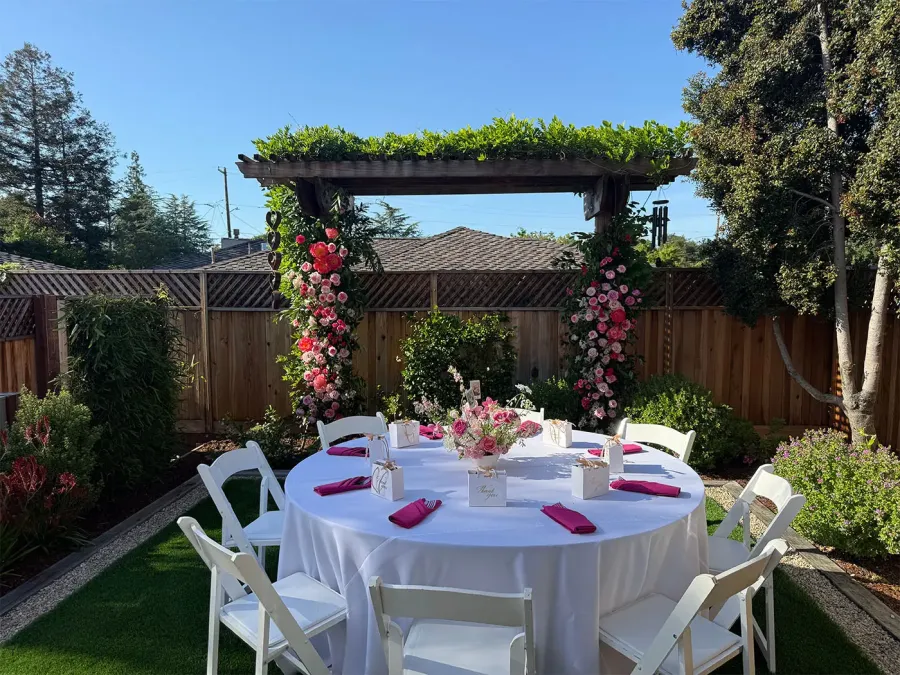 In-house floral arch of roses and greenery framing a ceremony at a Walnut Creek wedding by Winslow's Catering Concord