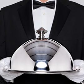 Black and tie waiter serving a dish for italian food catering east bay
